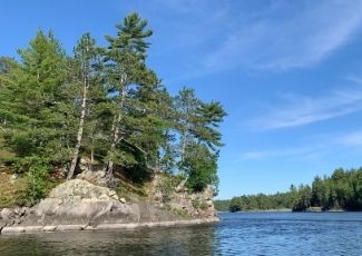 rocky and treed shoreline on lake